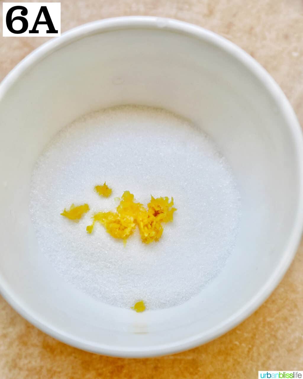 white bowl with sugar and lemon zest.