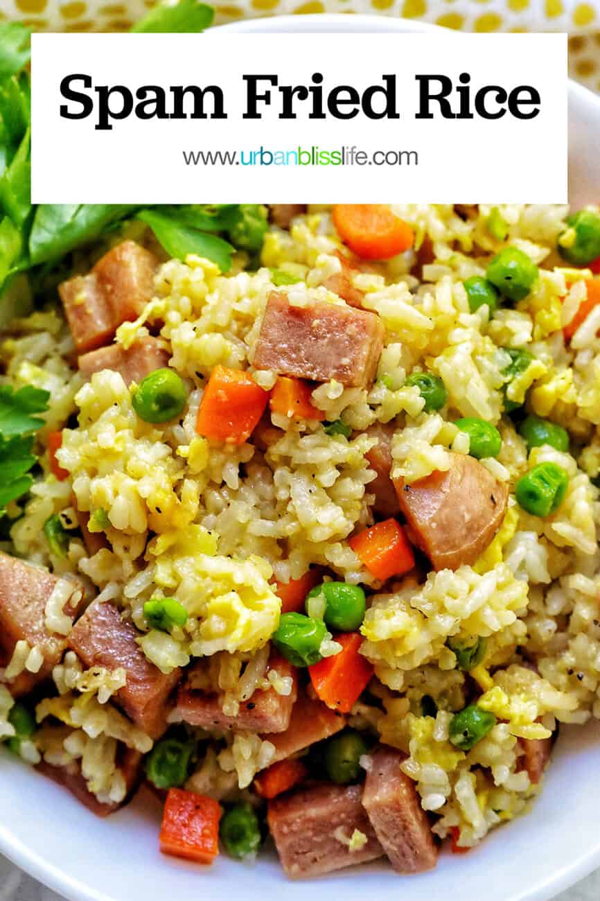 spam fried rice with peas, carrots, and parsley garnish in a white bowl with title text that reads "spam fried rice."