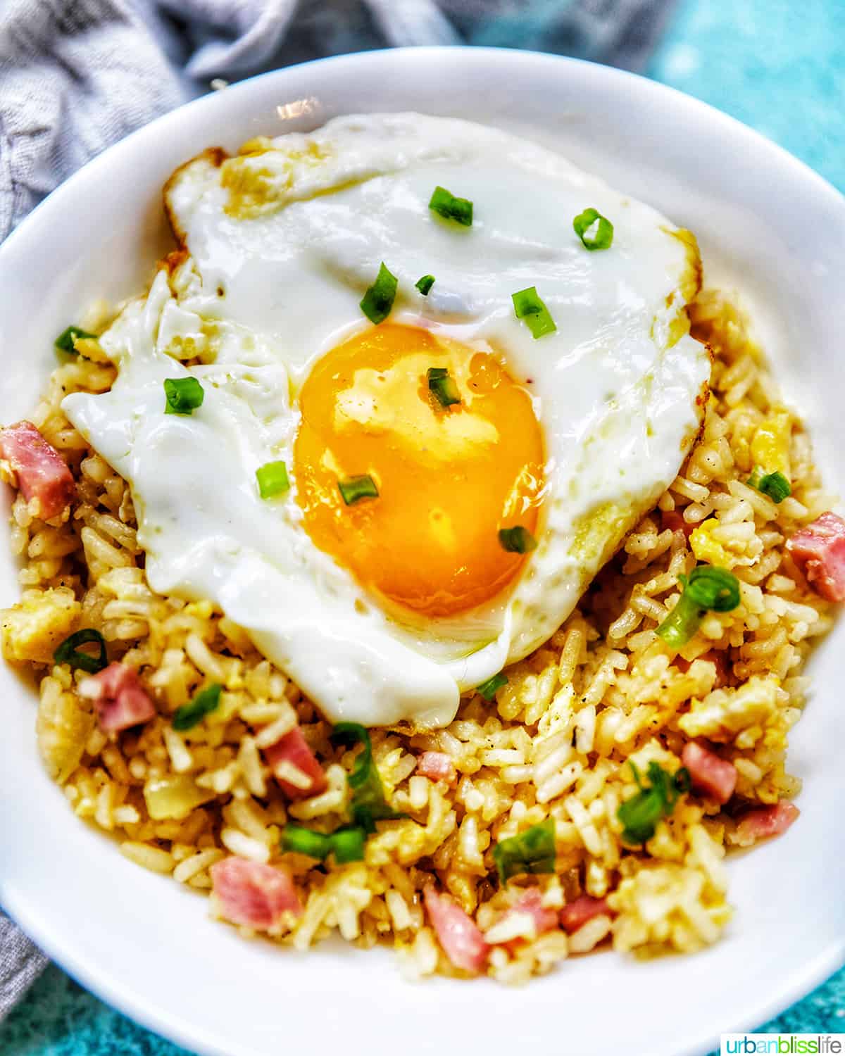 Spam Fried Rice with egg in a white bowl.