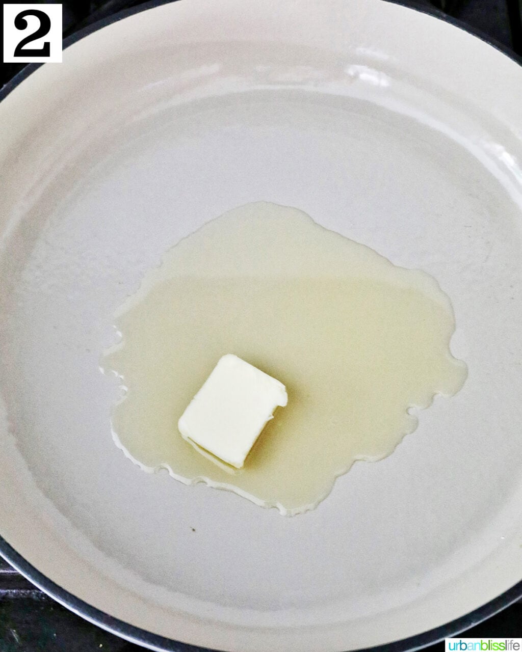 butter melting in a white saucepan.