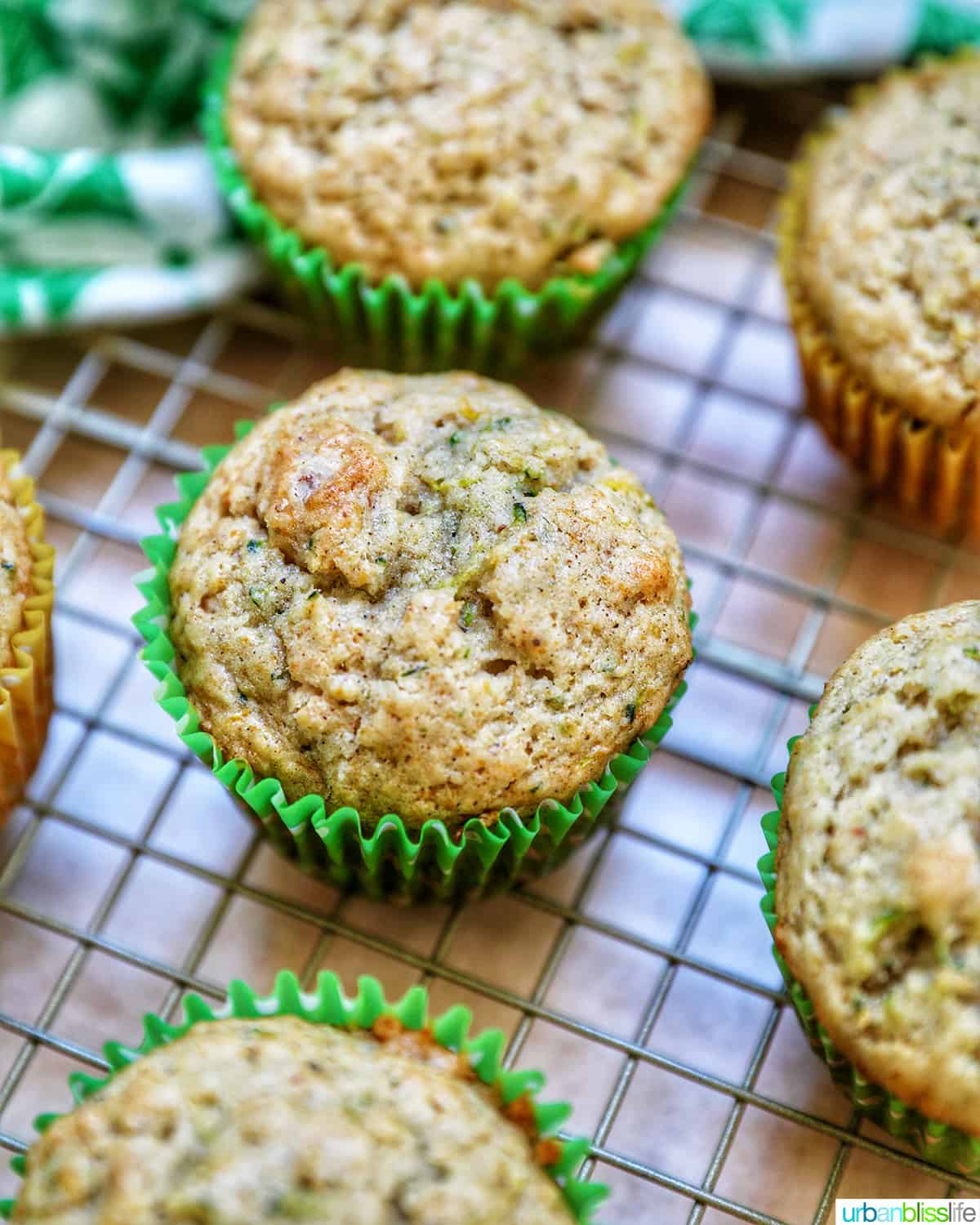 vegan zucchini muffins on a wire rack.