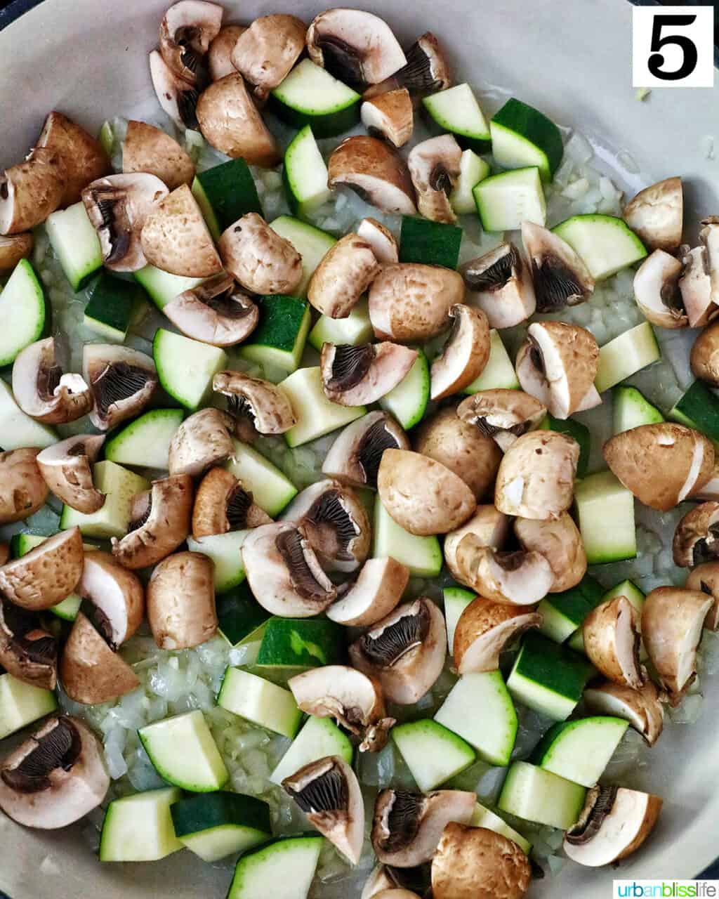 chopped mushrooms and zucchini in a saucepan.