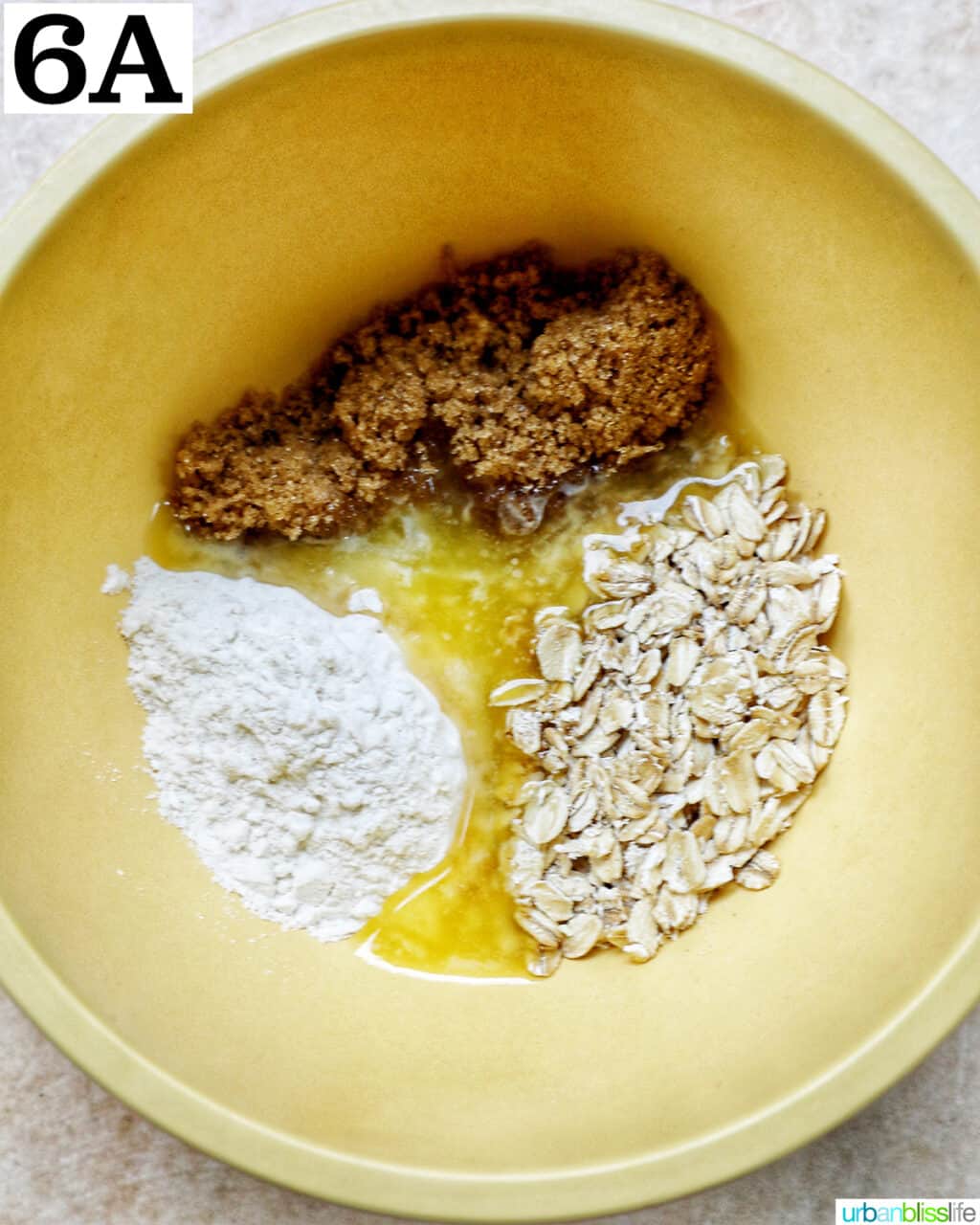 yellow bowl with oats, sugar, and flour to make a streusel topping.