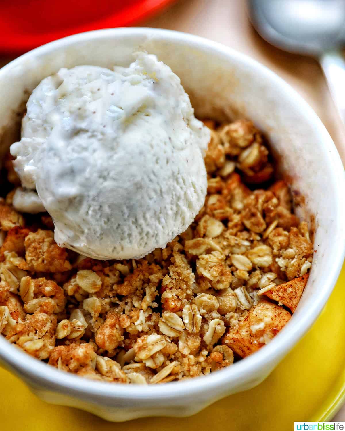 bowl of Air Fryer Apple Crisp with scoop of ice cream.