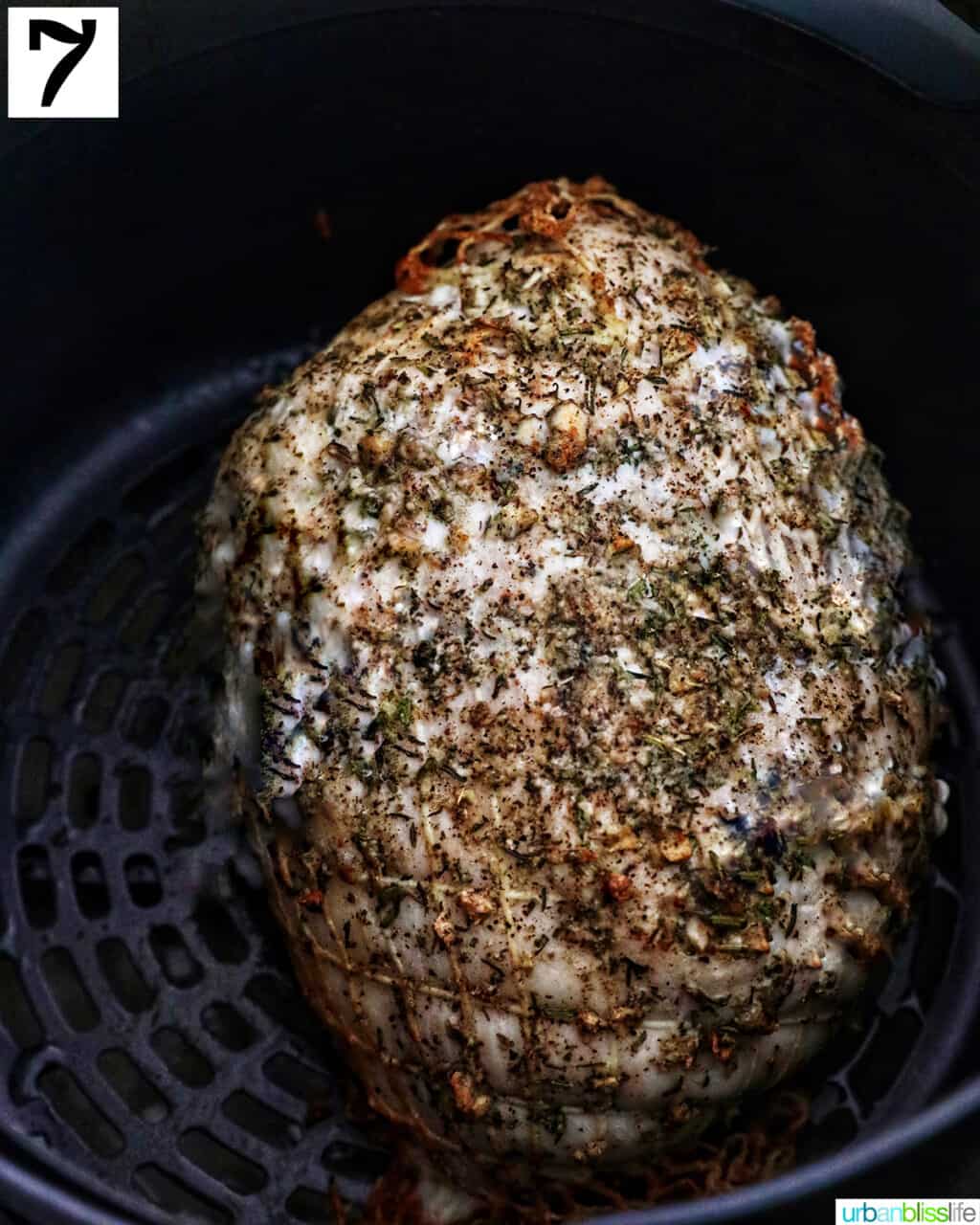 cooked turkey breast in an air fryer basket.