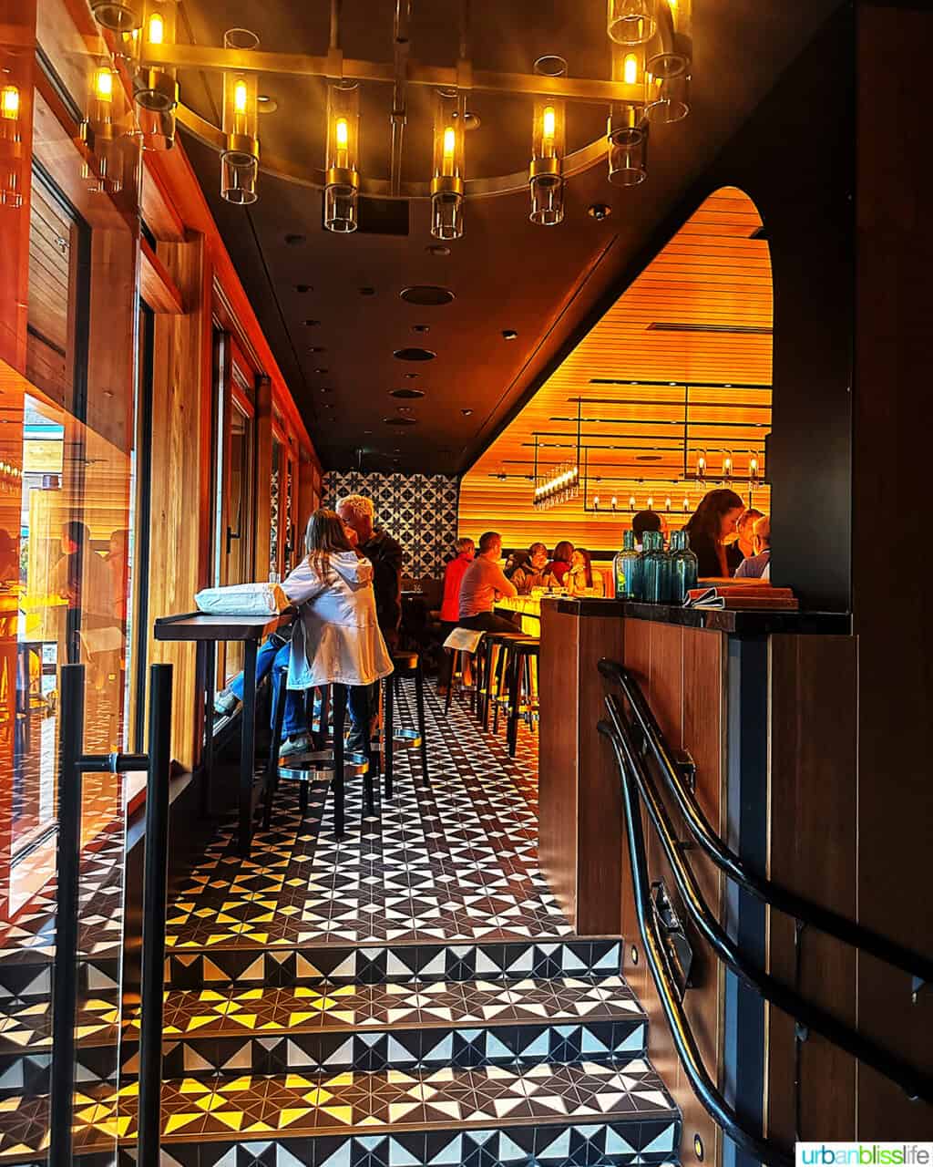 patterned tile floor and entrance tables and bar at Bar Oso restaurant in Whistler BC Canada.