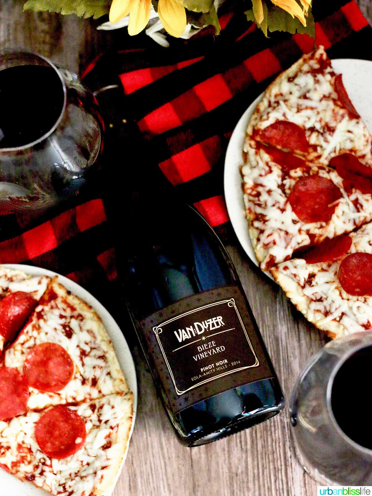 bottle of red wine with pepperoni pizza