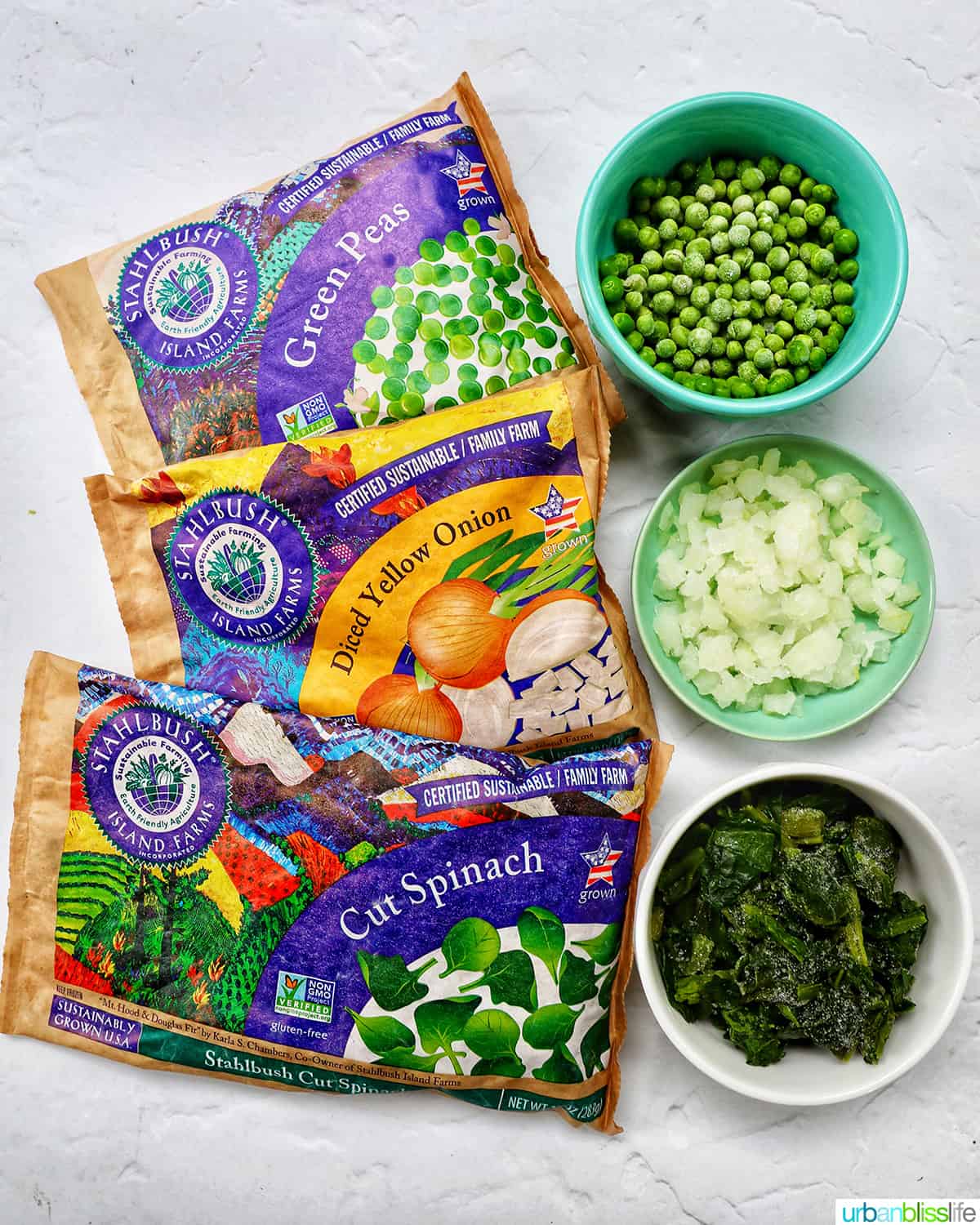 three packages of frozen vegetables next to bowls of frozen vegetables.