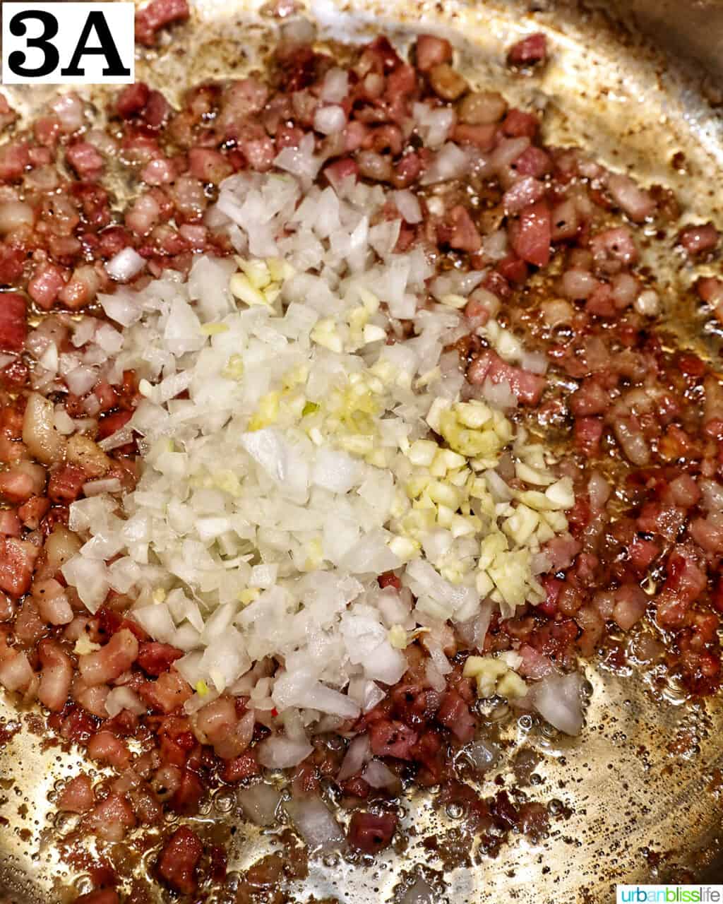 diced onions, minced garlic, and chopped bacon cooking in a saucepan.