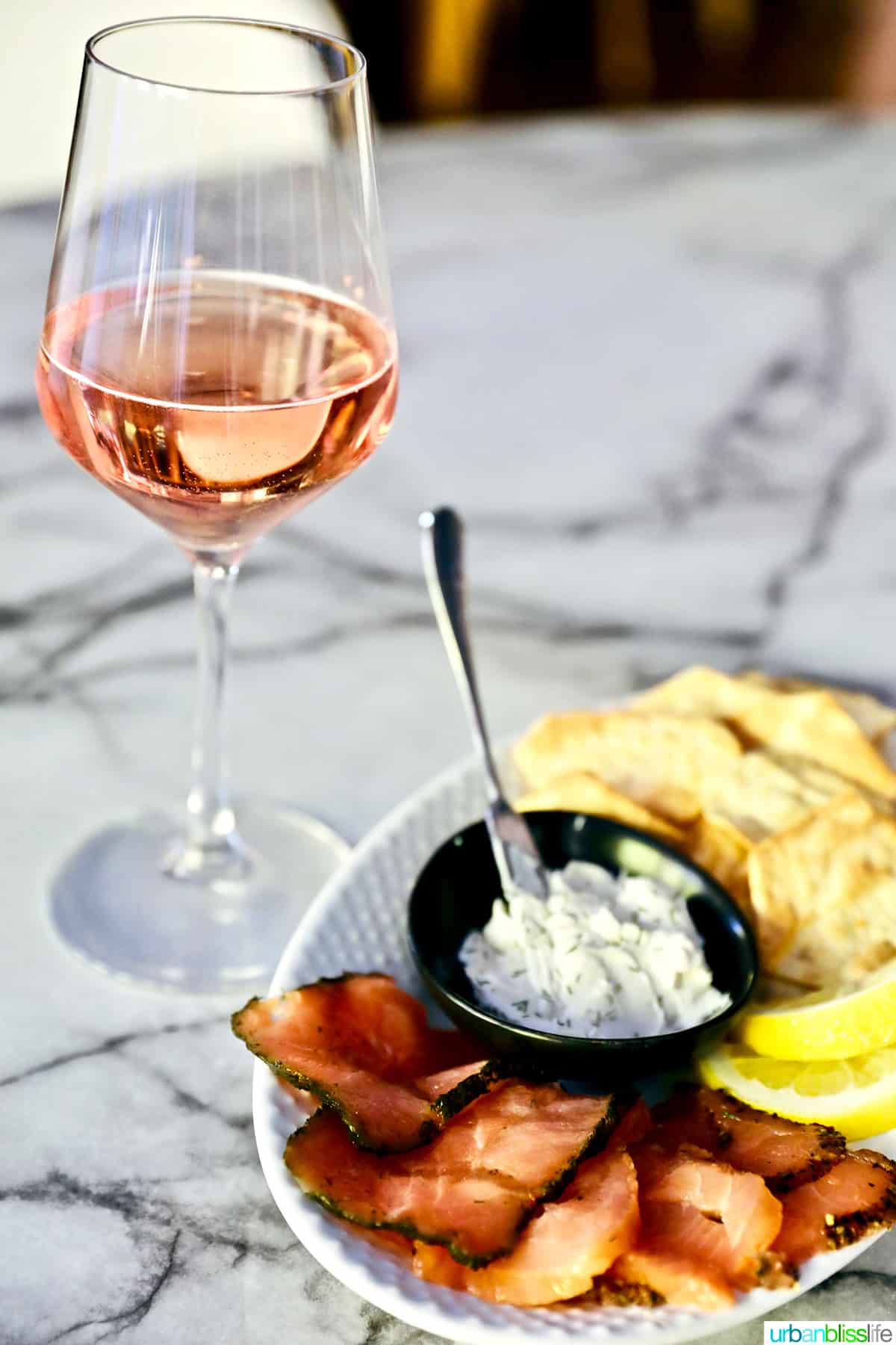 plate of smoked salmon and dip with glass of rosé wine.