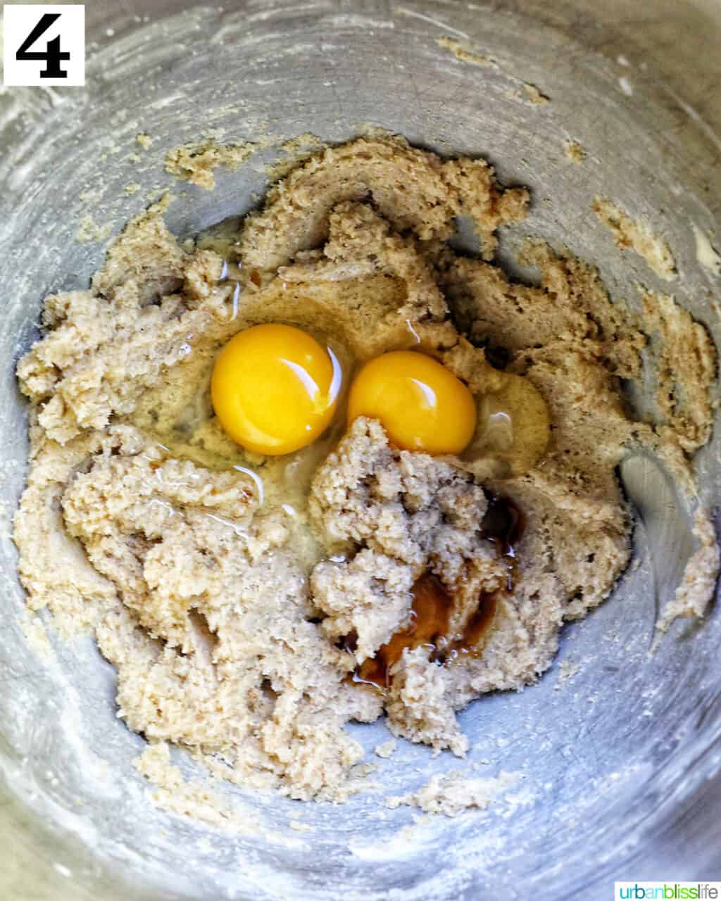 eggs added to wet batter in a stand mixer bowl.