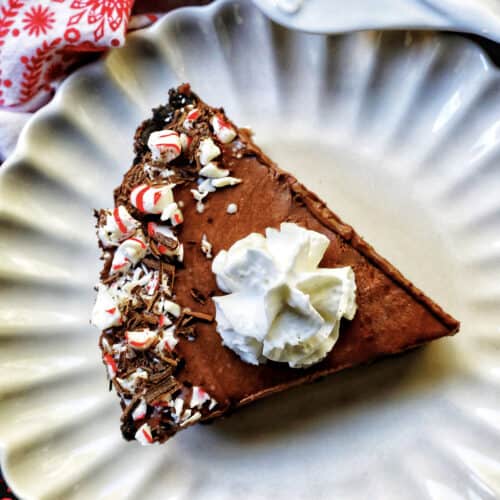 slice of Chocolate Peppermint Pie on a scalloped plate.