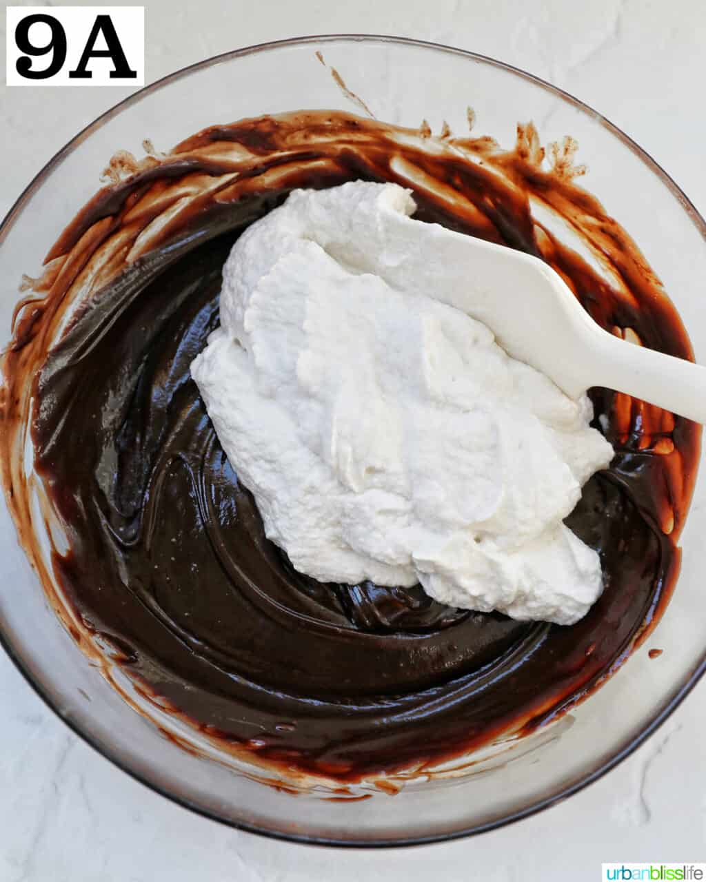 folding whipped cream into melted chocolate.