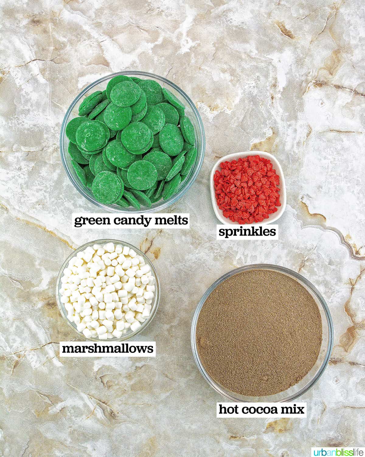 bowls of ingredients to make Grinch hot chocolate bombs.
