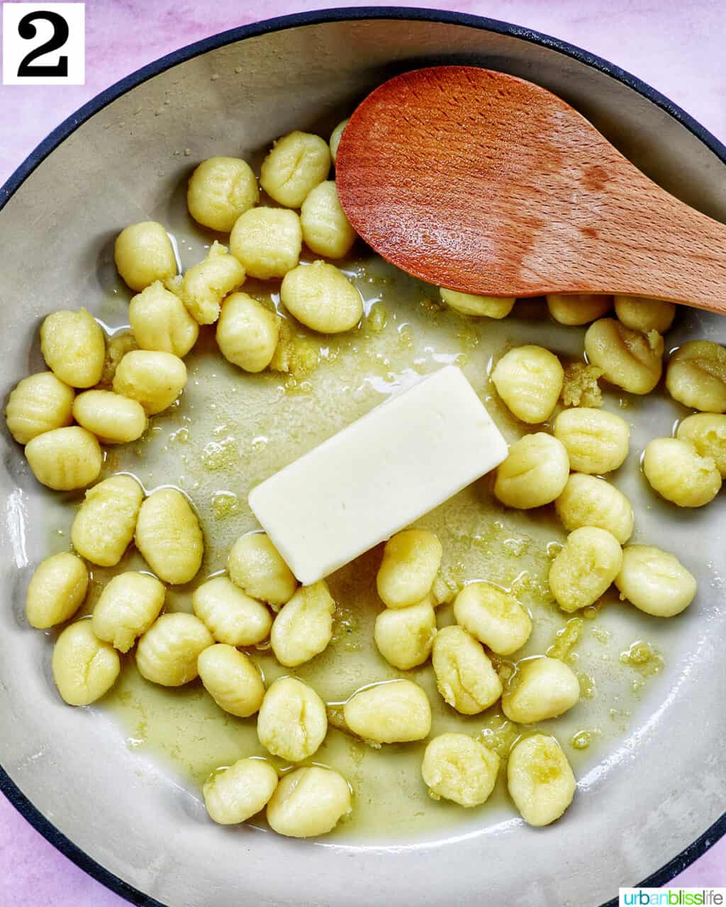 gnocchi and butter cooking together in a skillet.