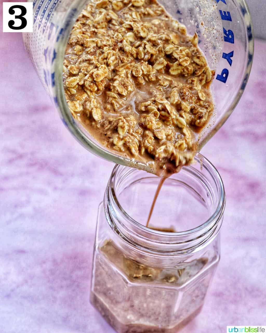 pouring overnight oats ingredients into a mason jar.