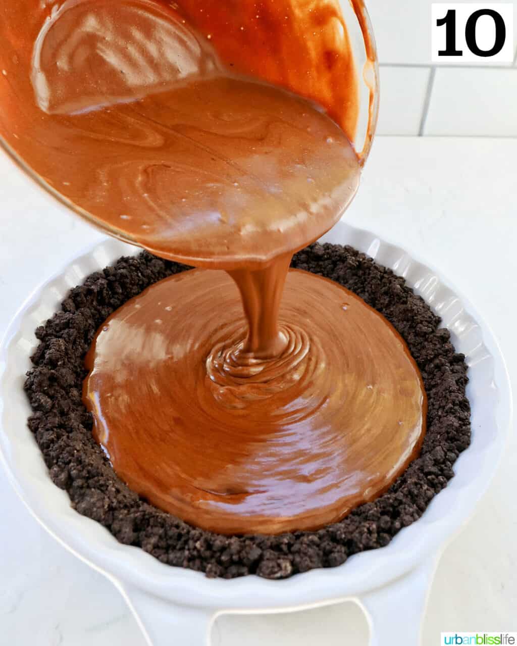 pouring chocolate pie filling into an oreo cookie crust.