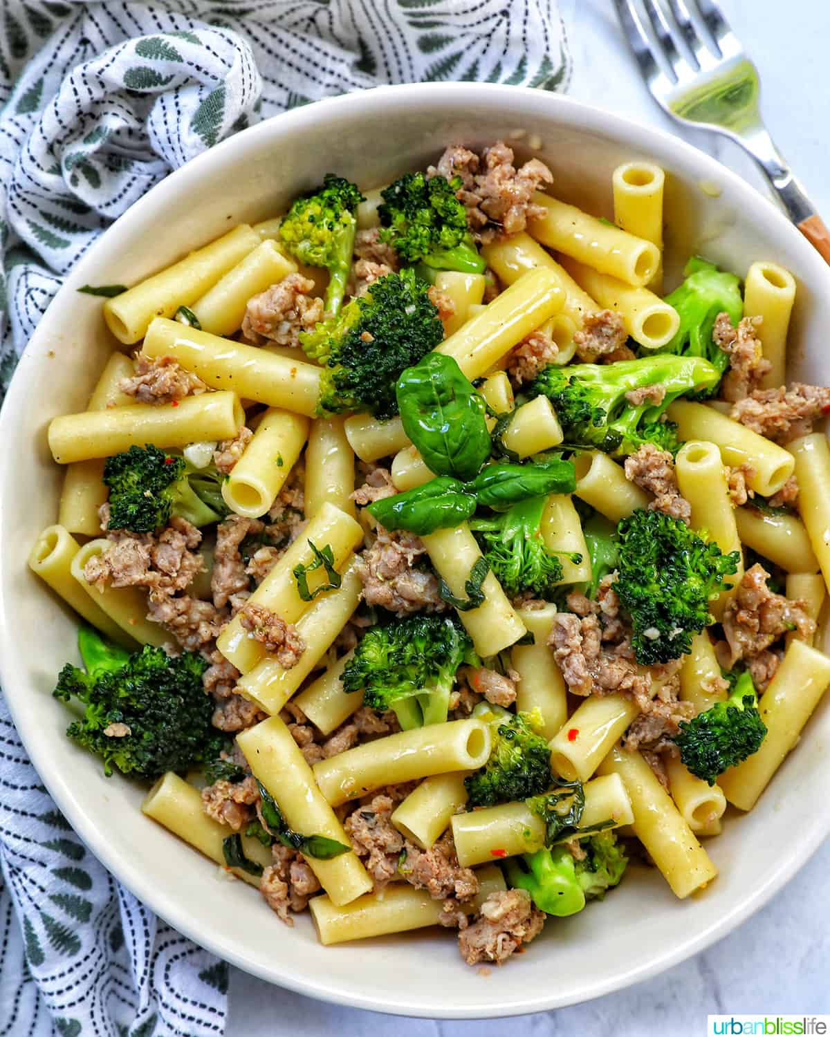 big bowl of ziti pasta with Italian sausage and broccoli.