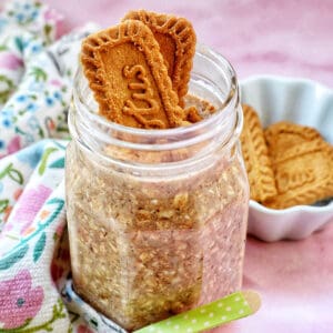 Biscoff overnight oats in a jar with crumbled Biscoff cookies on top.