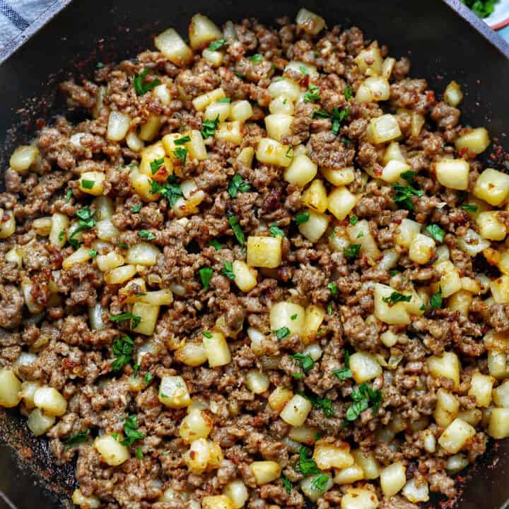 breakfast sausage potato hash in a cast iron skillet.