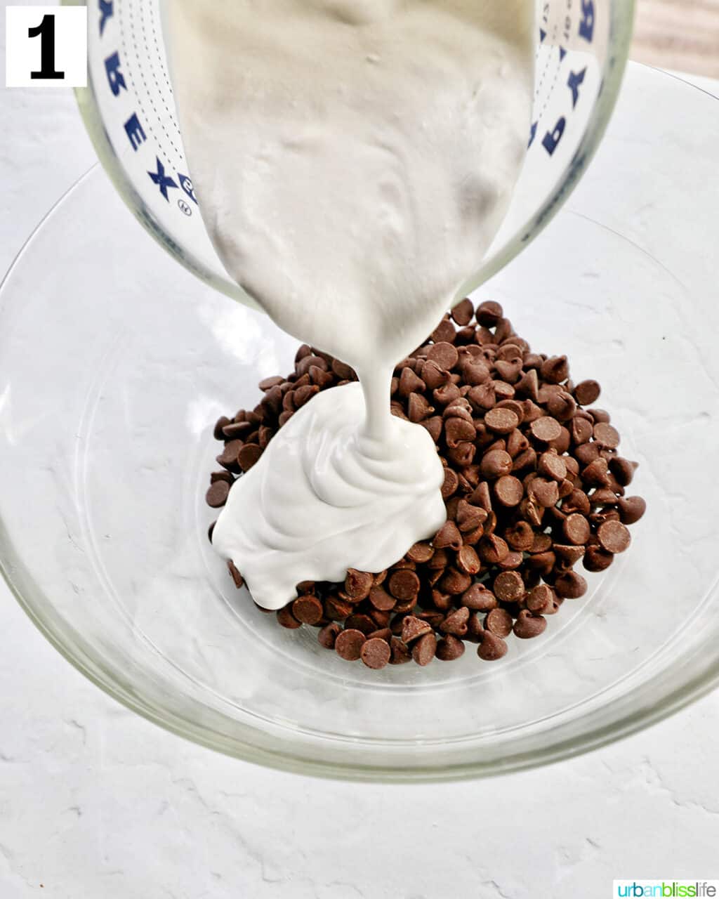 pouring heavy cream into a bowl with chocolate chips.