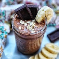 chocolate protein overnight oats topped with banana slices and chocolate pieces.