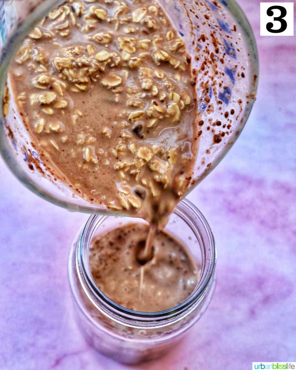 pouring chocolate protein overnight oats from a large glass bowl into a mason jar.