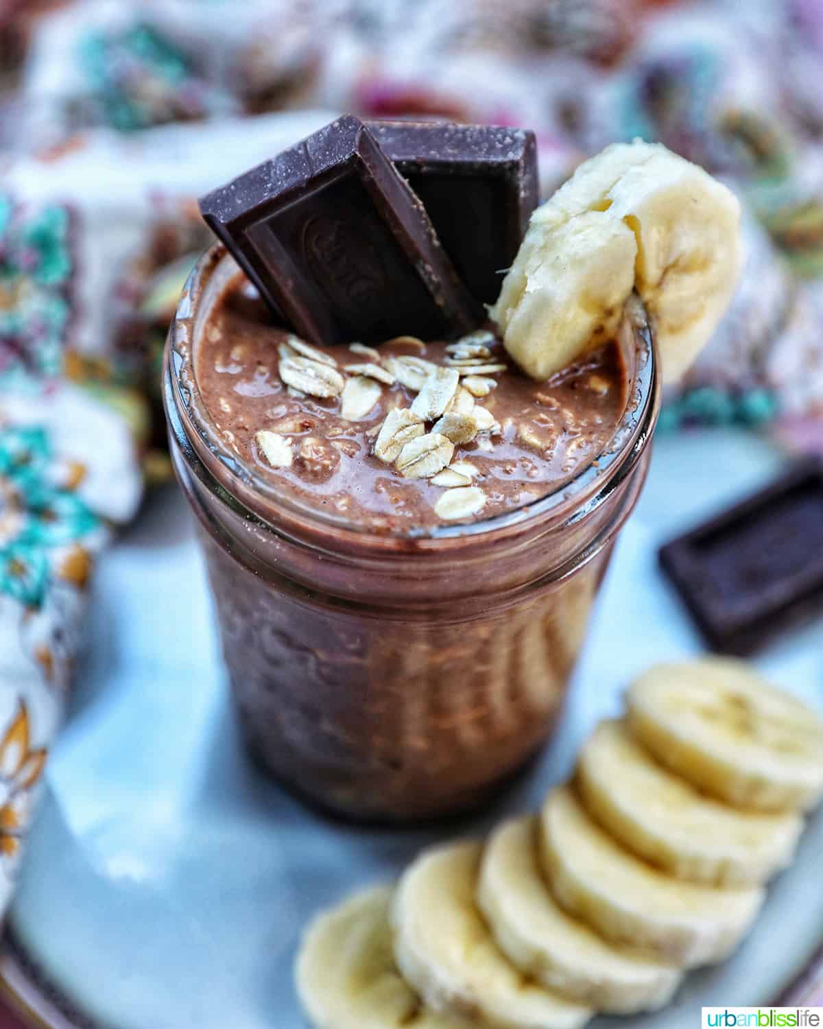 chocolate protein overnight oats topped with banana slices and chocolate pieces.