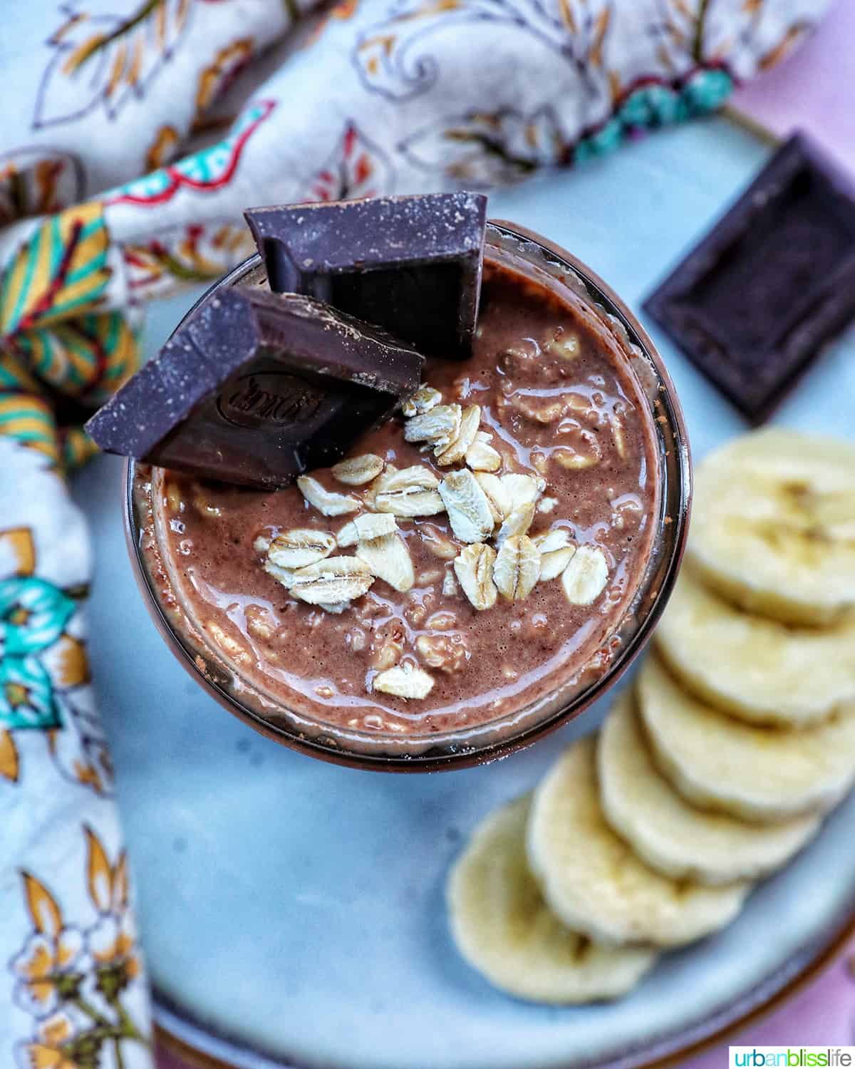 chocolate protein overnight oats topped with banana slices and chocolate pieces.
