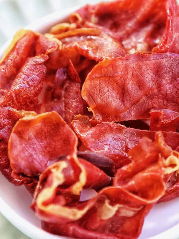 crispy prosciutto in a small white bowl.