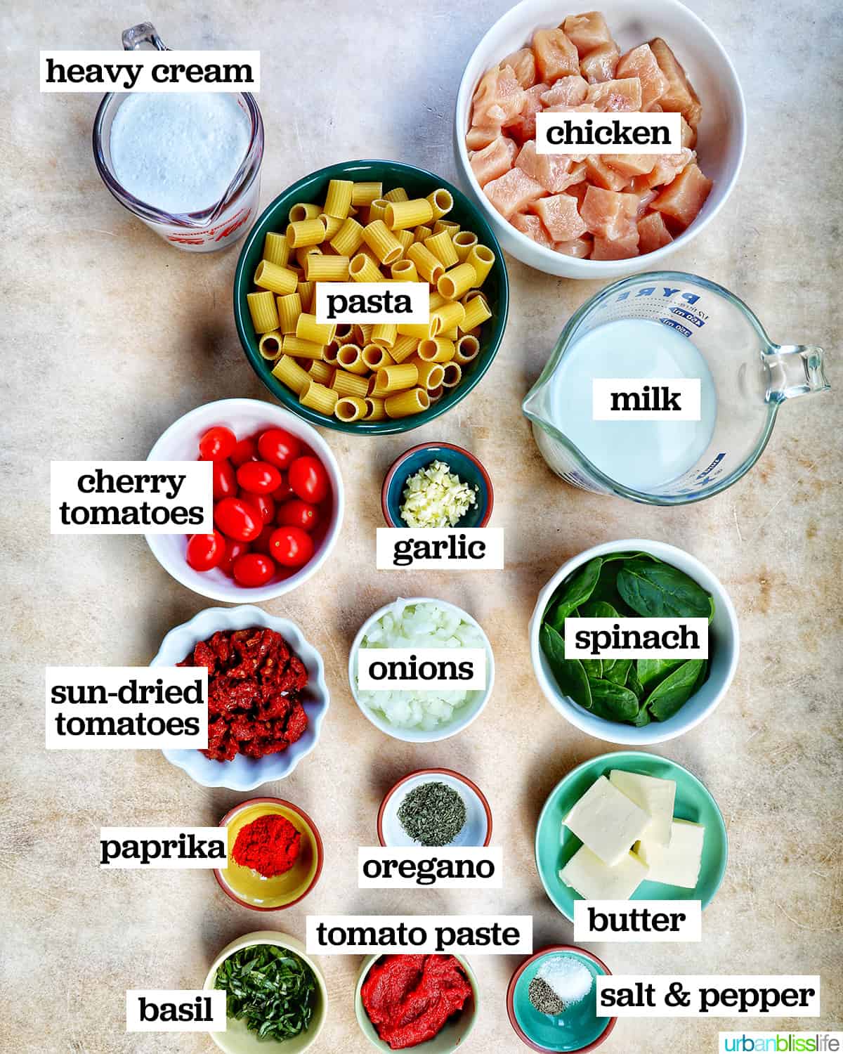 bowls of ingredients to make a creamy tuscan pasta recipe.