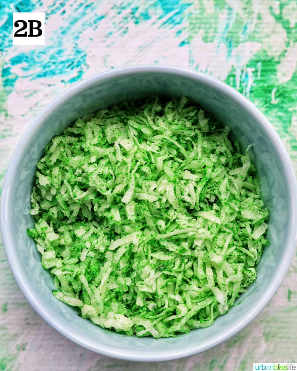 green colored shredded coconut in a bowl.