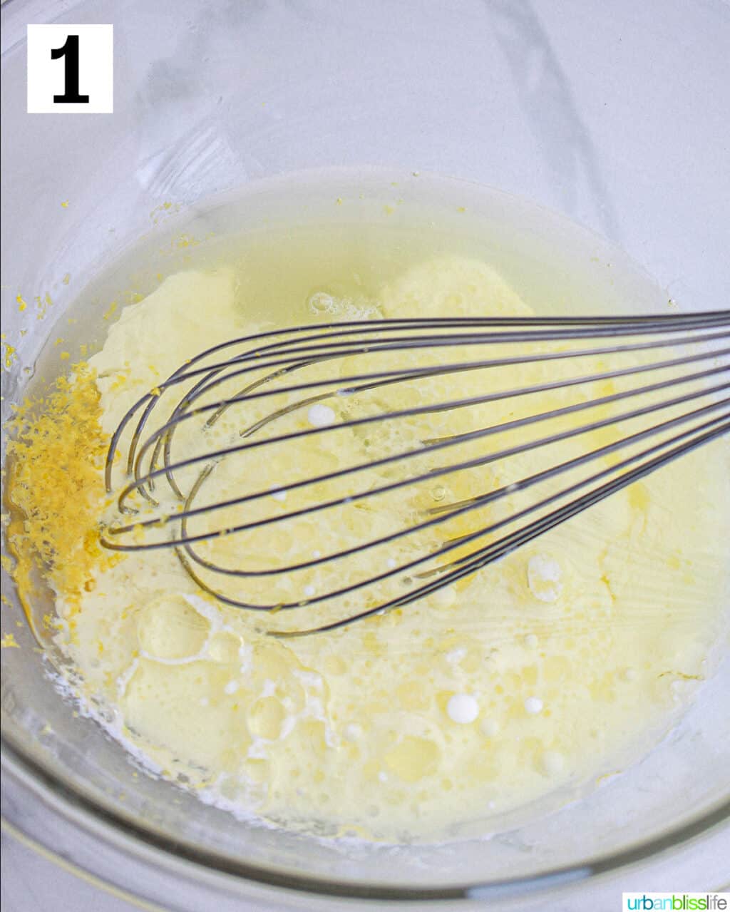 whisk in a bowl with cupcake batter.