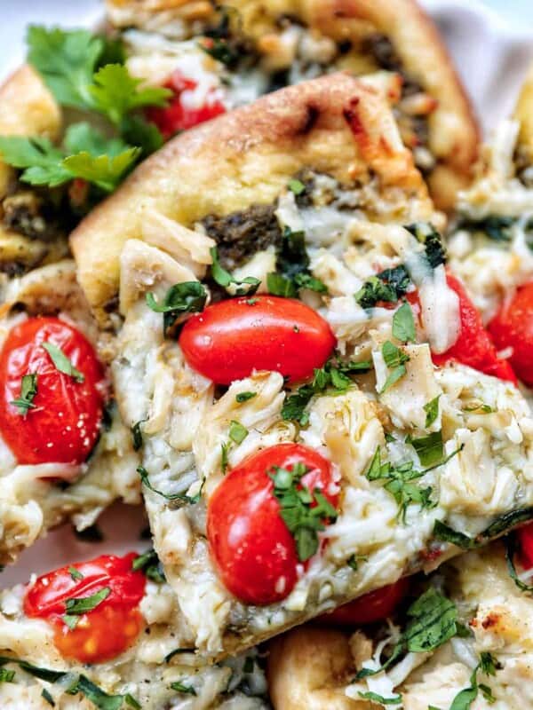 slices of chicken pesto flatbread on a plate.