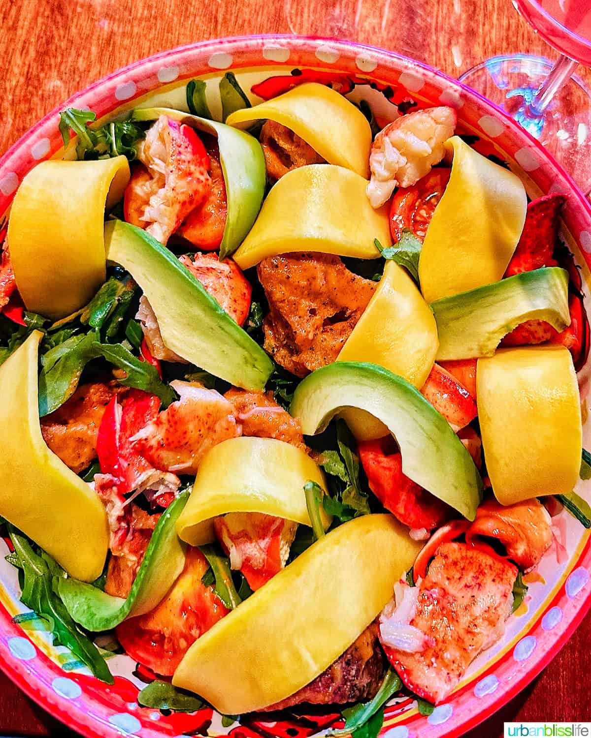 large bowl of lobster mango salad at Bad Roman restaurant in New York City.