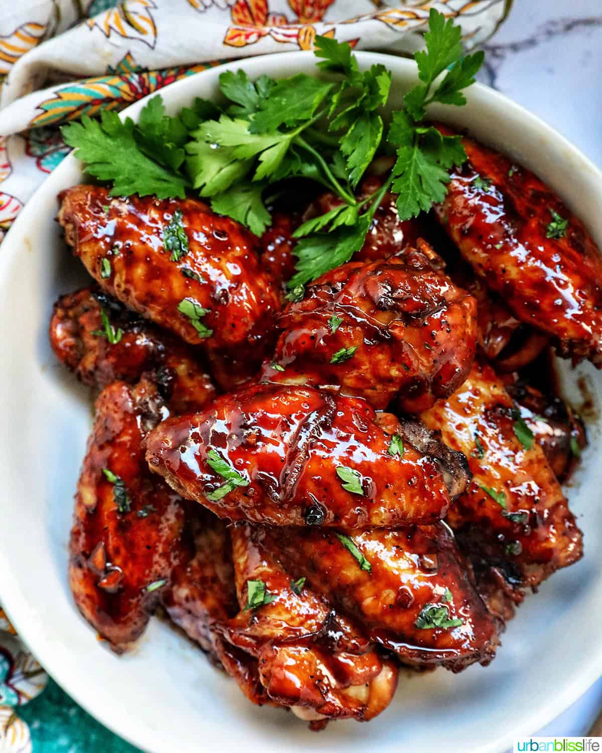 bowl of Filipino adobo chicken wings and fresh parsley.