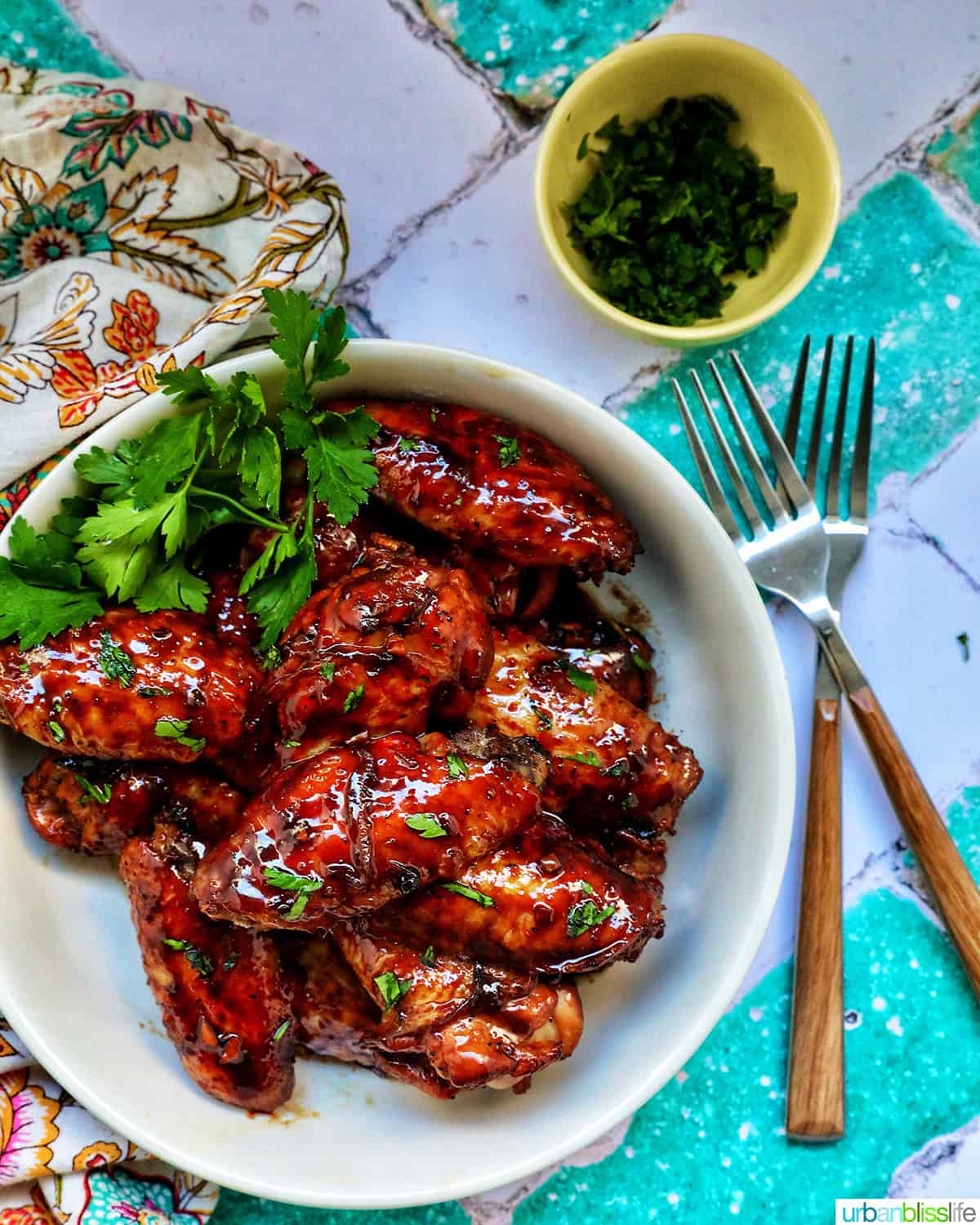 bowl of Filipino adobo chicken wings and fresh parsley.