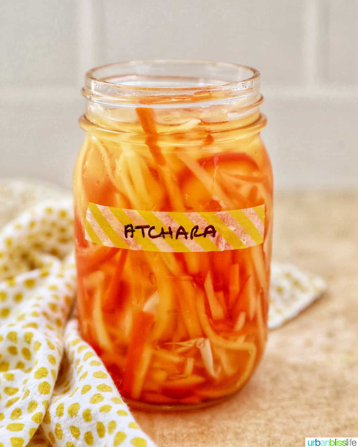 mason jar with Filipino atchara condiment - papaya, carrots, red bell pepper, garlic, ginger.