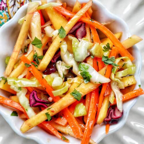 mango slaw with cabbage, carrots, red bell pepper, mango.