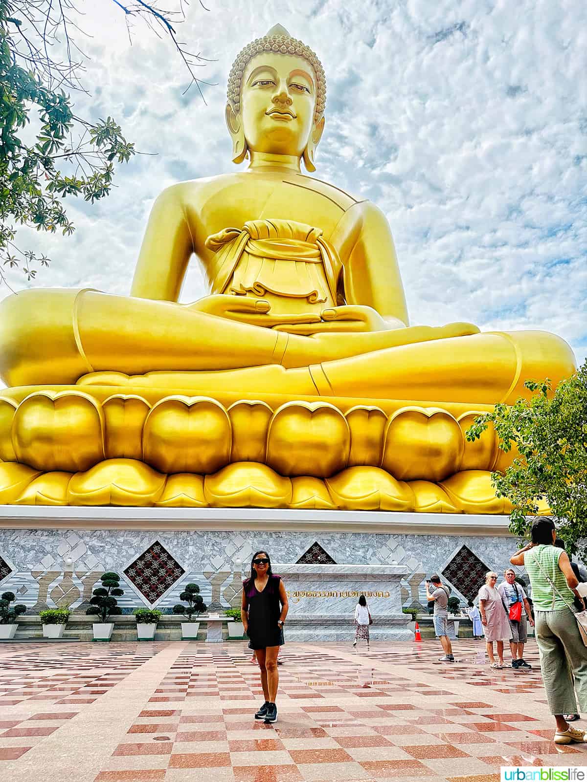 Marlynn Jayme Schotland in front of the big gold buddha in Bangkok Thailand.
