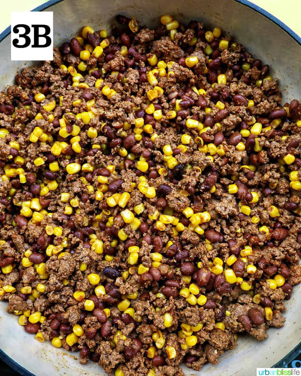 ground beef, beans, and corn cooking in a pan.