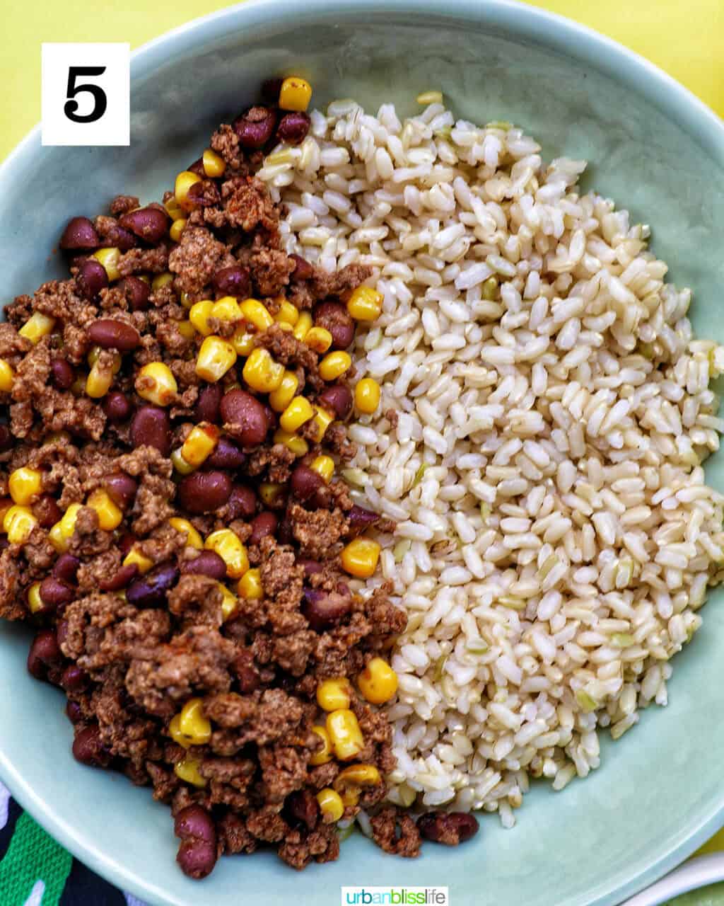 bowl of brown rice and beef, beans, corn.