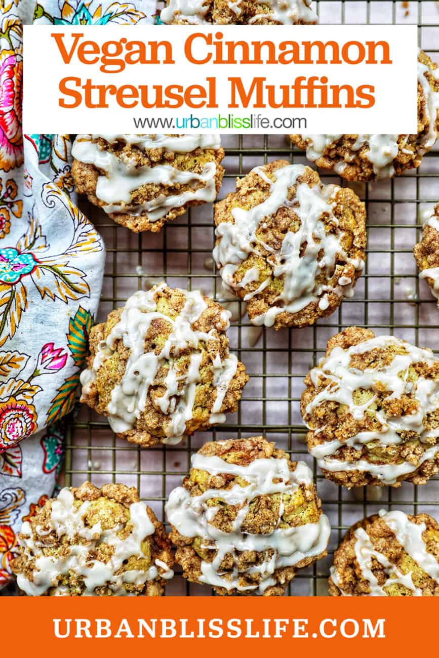 several vegan cinnamon streusel muffins on a wire rack with a colorful floral napkin with title text overlay.