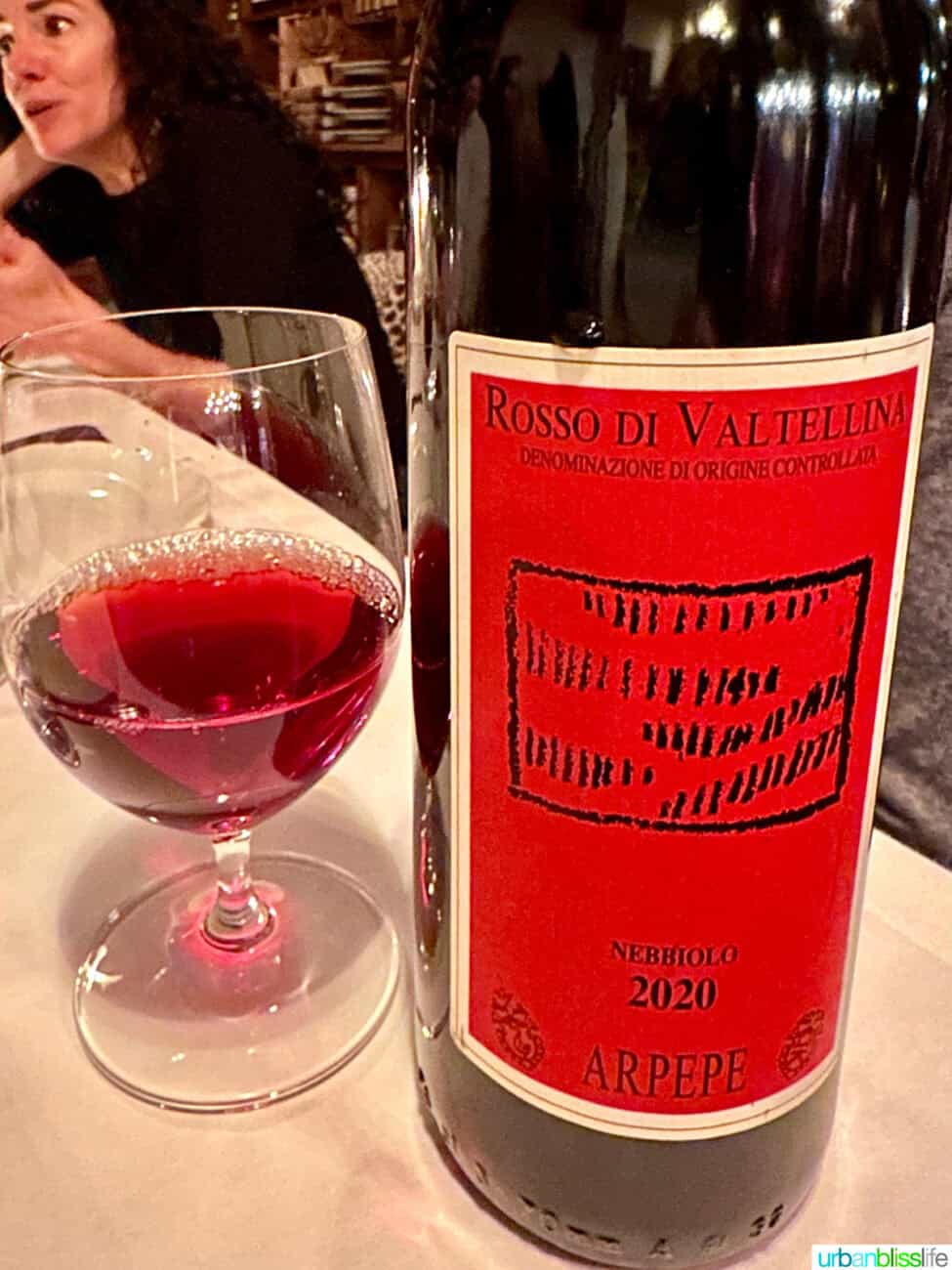 Bottle and glass of nebbiolo wine at Via Carota restaurant.