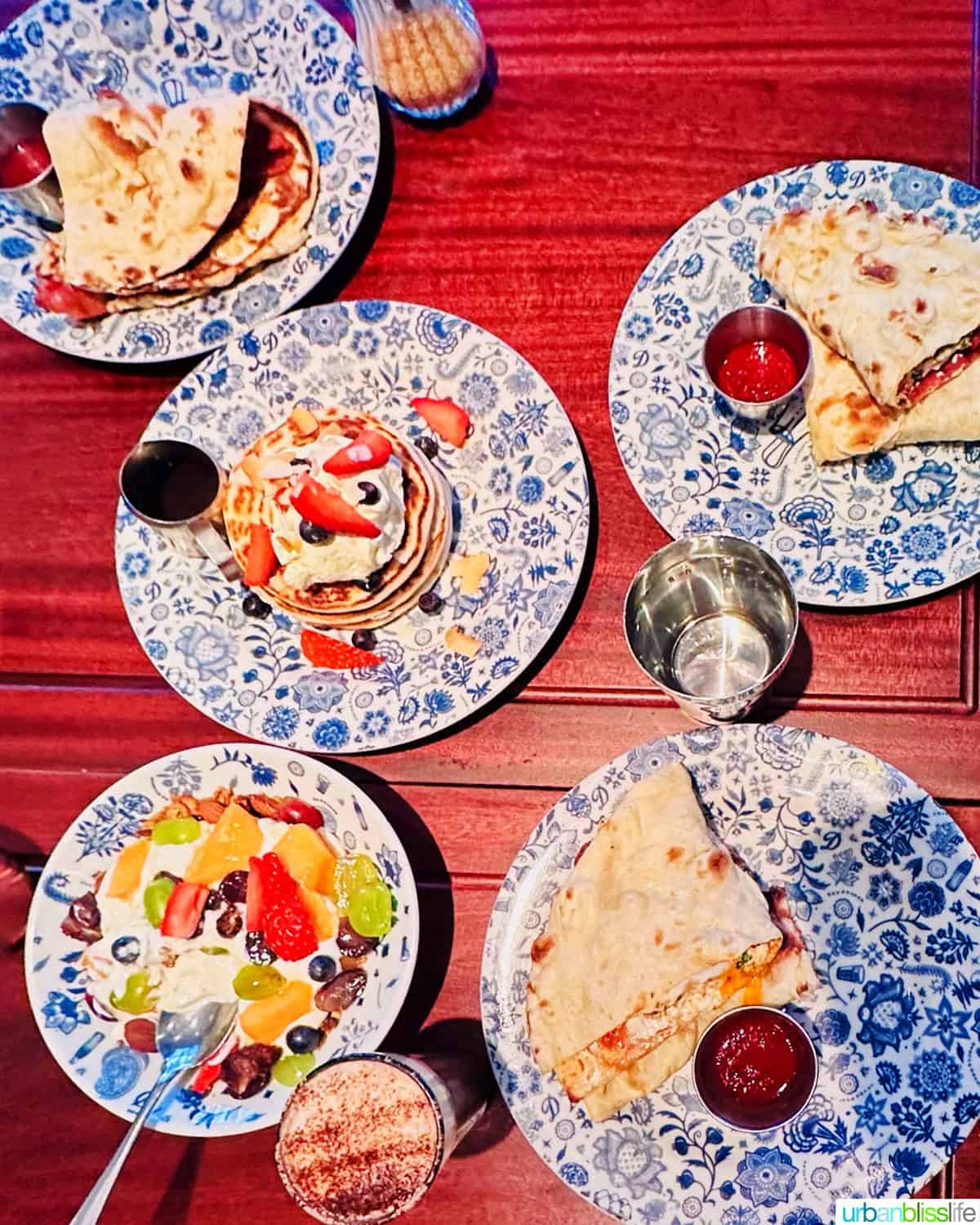 several plates full of breakfast in Covent Garden at Dishhoom restaurant in London, England.