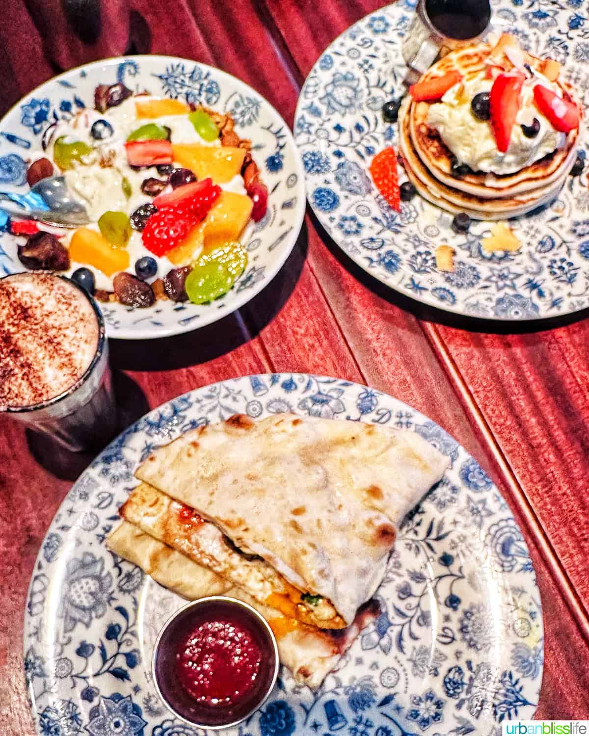 several plates full of breakfast in Covent Garden at Dishhoom restaurant in London, England.