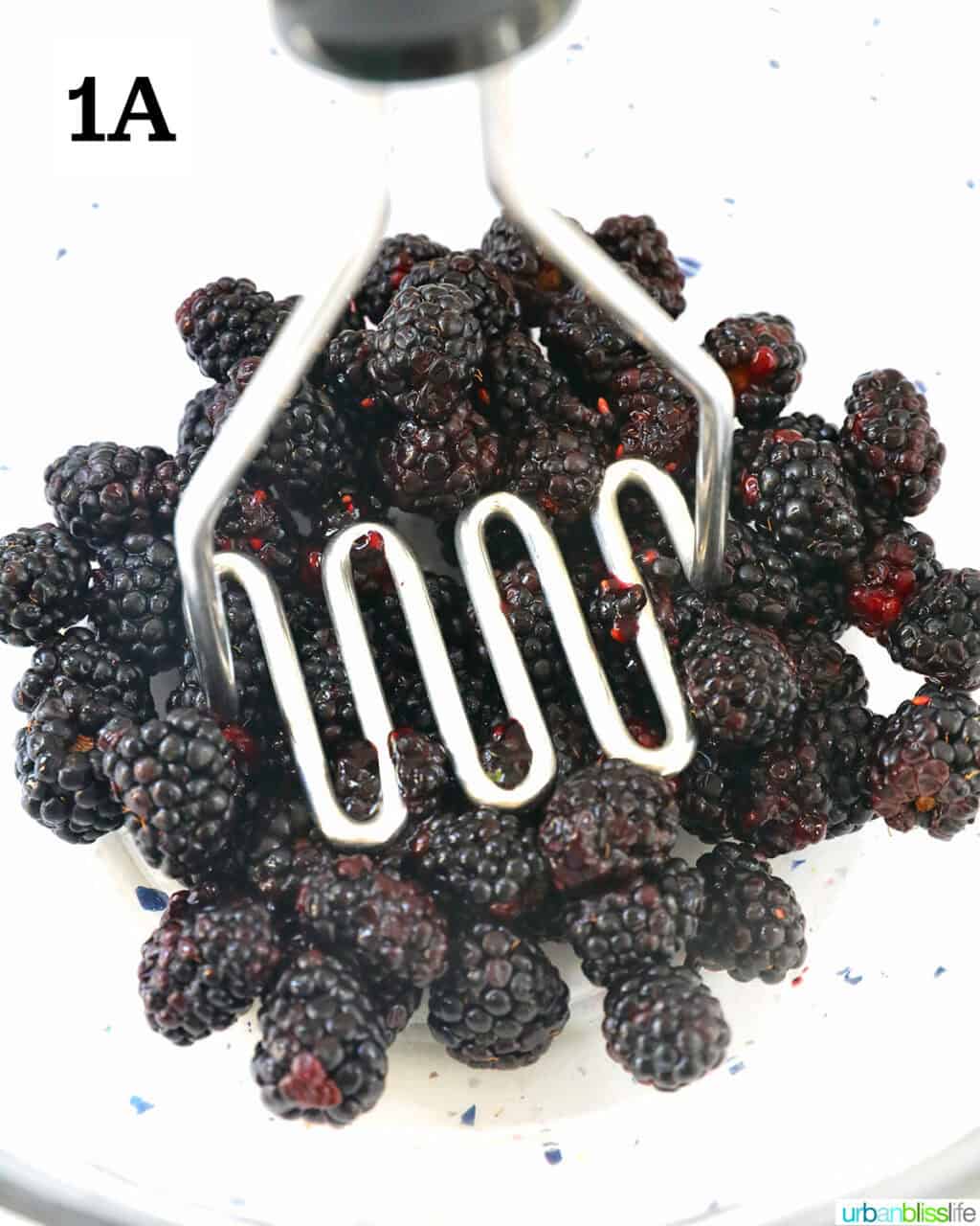 mashing blackberries to make jam.