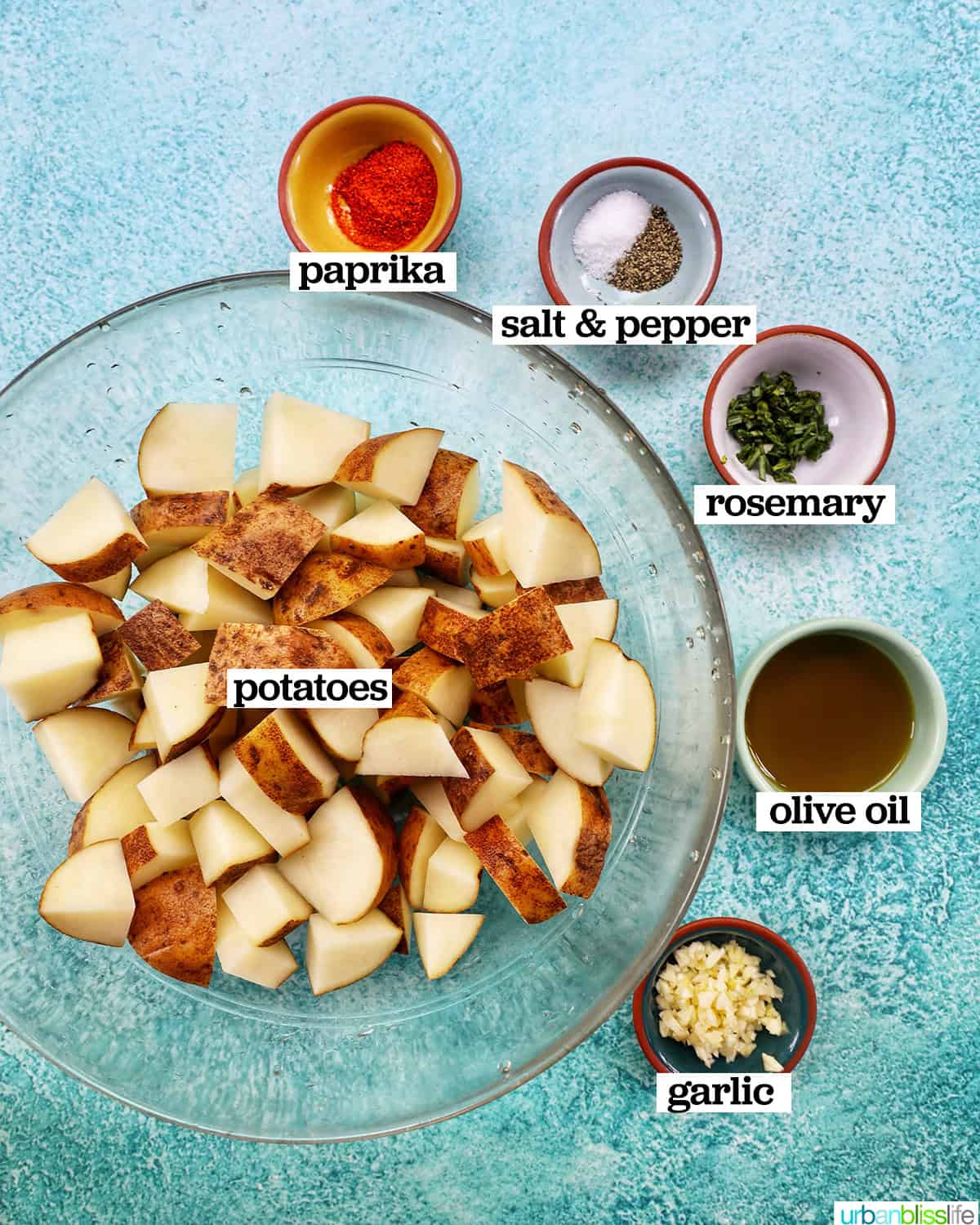 bowls of ingredients to make rosemary and garlic roasted potatoes.