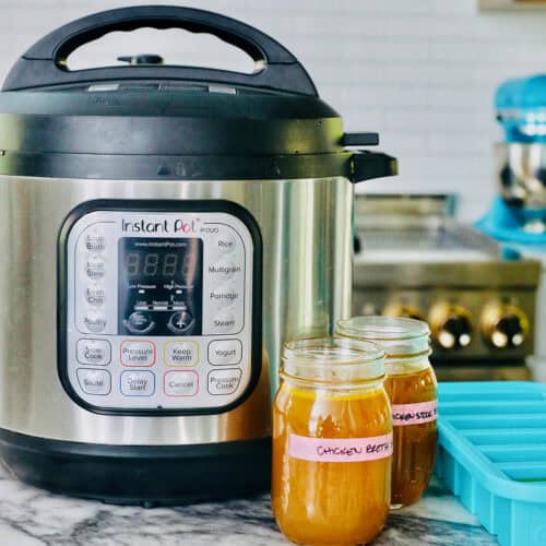 instant pot with jars of chicken stock.