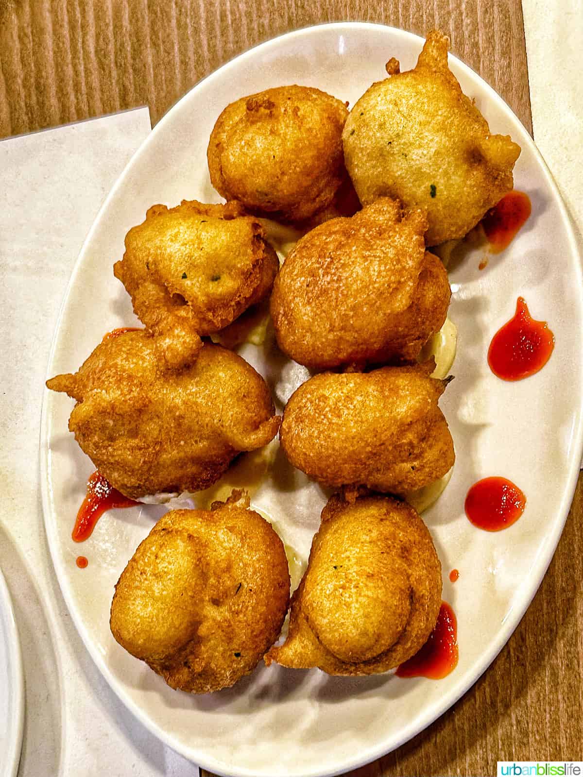 cod fritters on a serving plate.